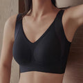 Black sports bra worn by a person against a neutral background